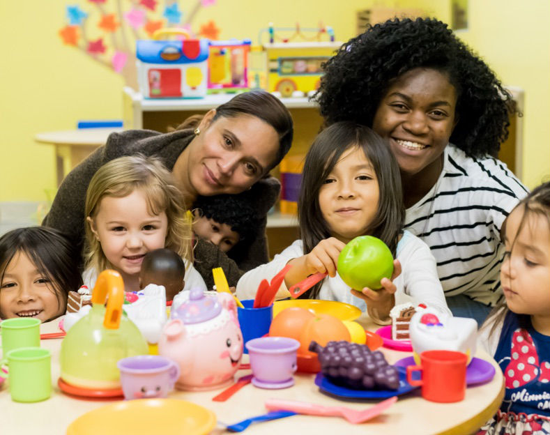 two teachers with happy students