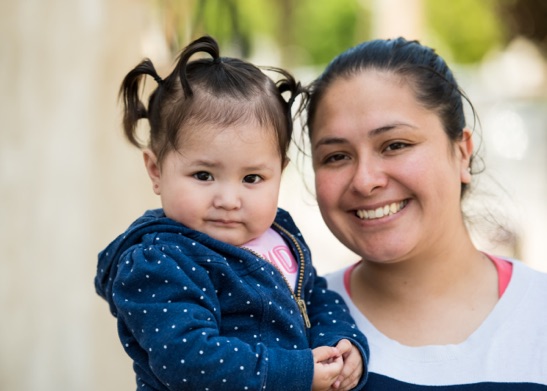 Mother holding daughter