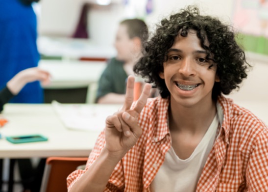 Teen holding up the peace sign