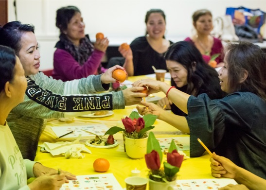 Women sharing oranges with each other