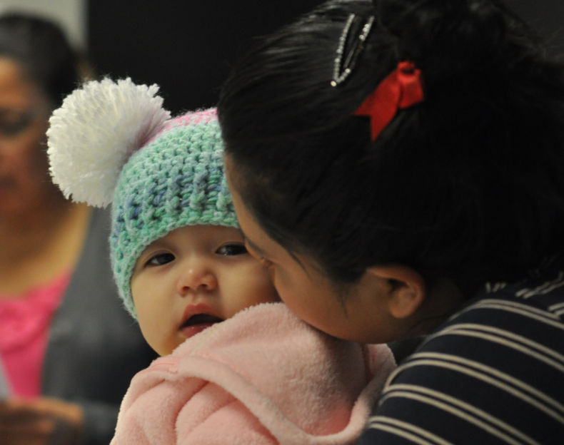 A mother holding infant