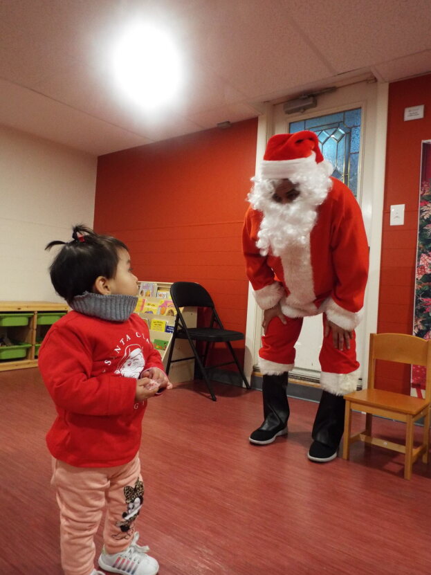 little girl and santa at holiday party
