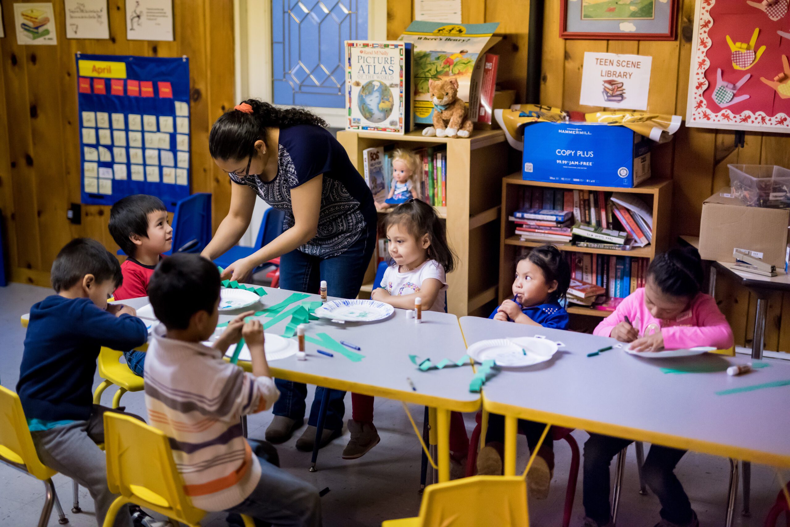 staff helping children with crafts